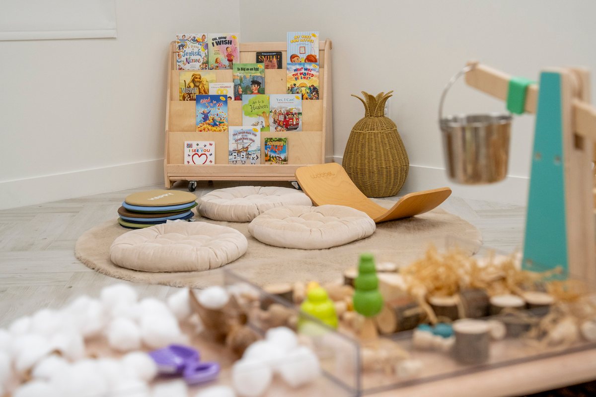 A cozy reading corner with cushions, books, and natural materials
